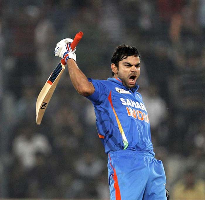Virat Kohli roaring in celebration with bat raised high after reaching century against Pakistan in Dhaka 2012