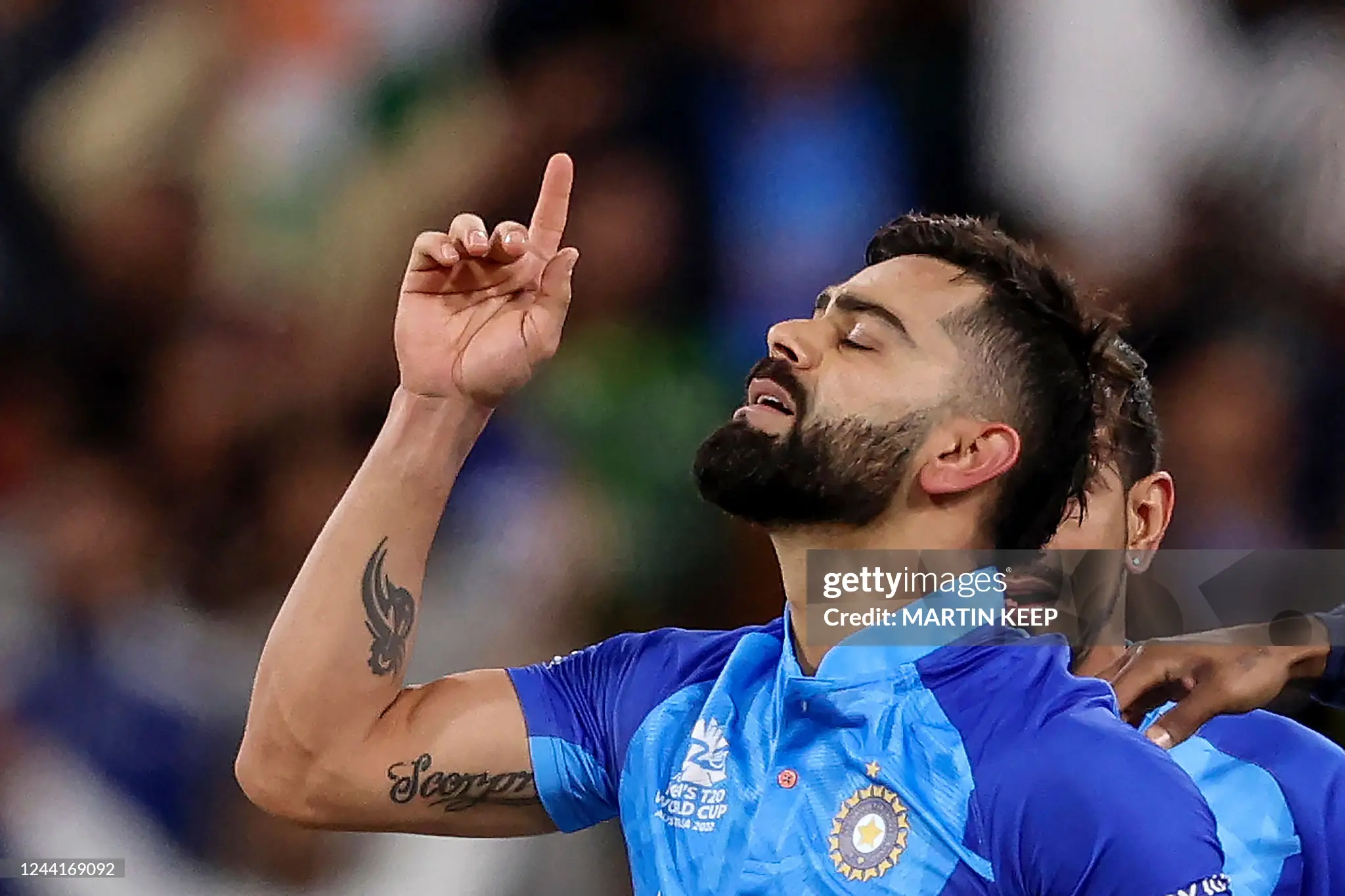 Virat Kohli with eyes closed pointing his right index finger to the sky in emotional thankfulness after winning 82* vs Pakistan at the MCG