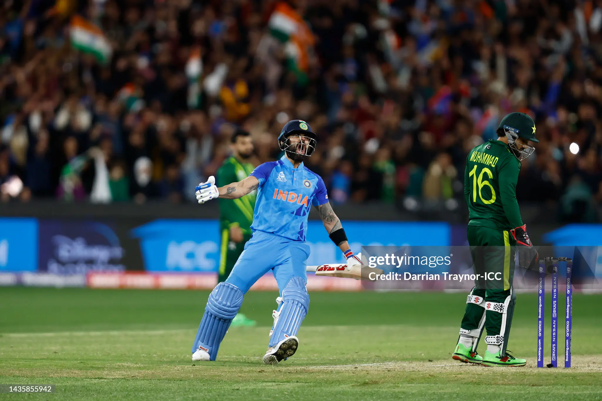 Virat Kohli with arms outstretched screaming in jubilation as the final winning run is scored against Pakistan at the MCG